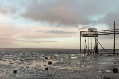 Fisheries on the edge of the atlantic ocean near la rochelle at dawn at low tide