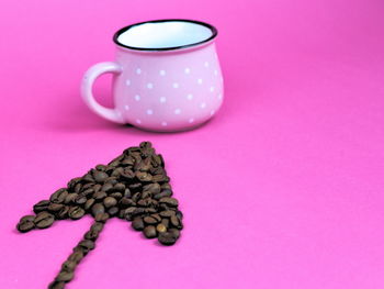 High angle view of heart shape on pink table