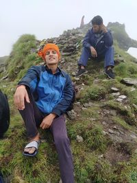 Portrait of friends sitting on land