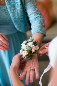 Midsection of woman holding flower bouquet