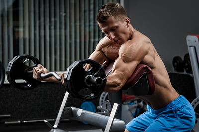 Side view of man exercising in gym