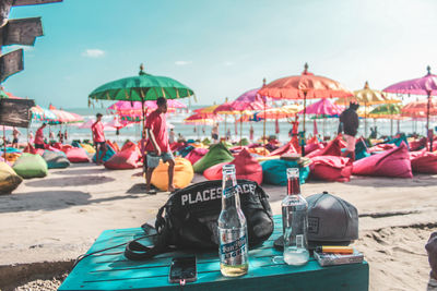 People at beach against sky