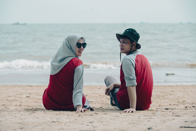 Friends sitting at beach