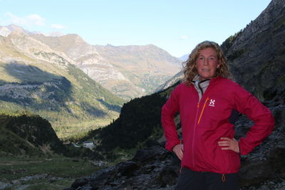 Portrait of woman standing on mountain against sky