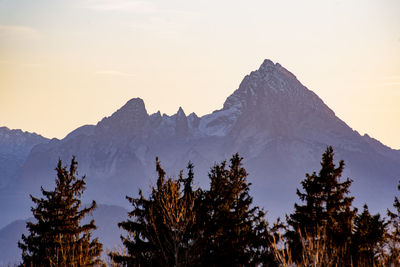 Scenic view of snowcapped mountains against sky during sunset