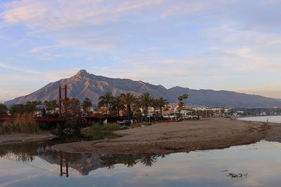 Scenic view of sea and mountains against sky