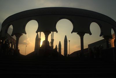 Low angle view of silhouette temple against sky