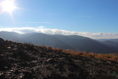 Scenic view of mountains against cloudy sky