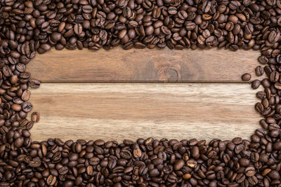 Directly above shot of roasted coffee beans on wooden table