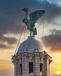 Low angle view of statue against sky during sunset