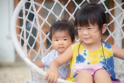 Portrait of cute girl sitting outdoors