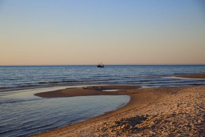 Scenic view of sea against clear sky during sunset