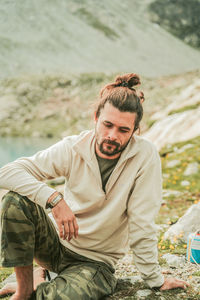 Portrait of young man sitting outdoors