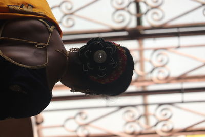 Close-up of black shoes on railing