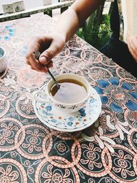 Midsection of person holding coffee cup