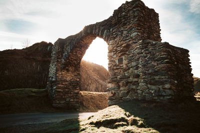 View of stone structure against cloudy sky