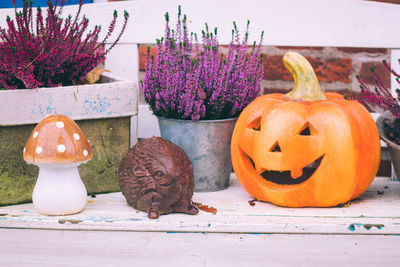 Close-up of pumpkin on flowers on table