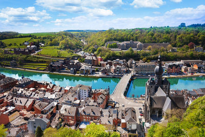 High angle view of townscape by river against sky