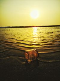 Close-up of sea against sky at sunset