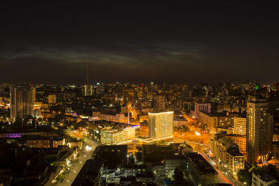 High angle view of illuminated cityscape against sky at night