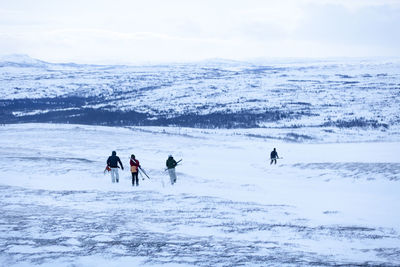 People hiking at winter, rear view