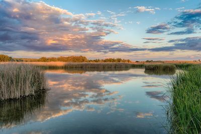 Scenic view of lake against sky during sunset