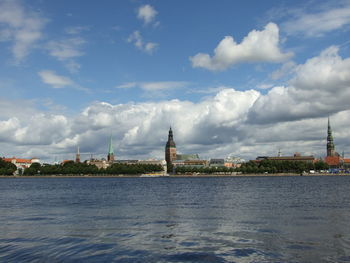 Statue of liberty in city against sky