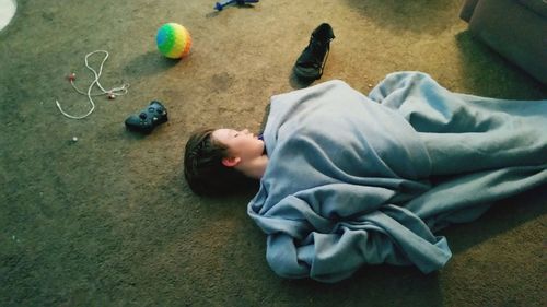Low section of child lying on floor