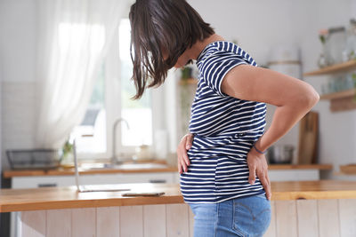 Rear view of woman standing in gym