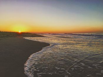 Scenic view of sea against clear sky during sunset