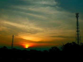 Silhouette trees against sky during sunset