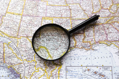 Close-up of magnifying glass on table