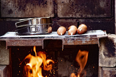 Close-up of burning candles on wood