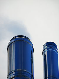 Low angle view of smoke stack top high section against sky - chrome large chrome