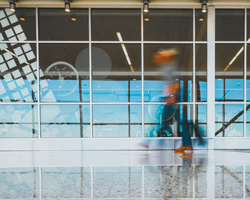 Low section of man walking by water