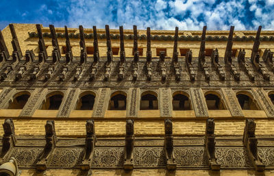 Low angle view of historical building against cloudy sky