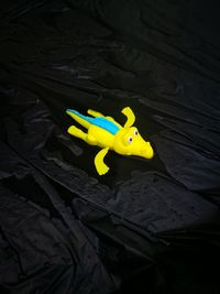 High angle view of yellow toy in car