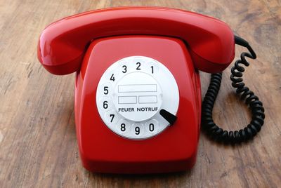 High angle view of telephone on wooden table