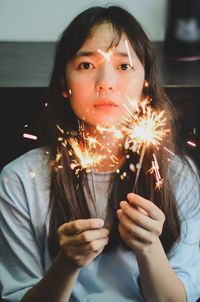 Portrait of girl holding sparkler