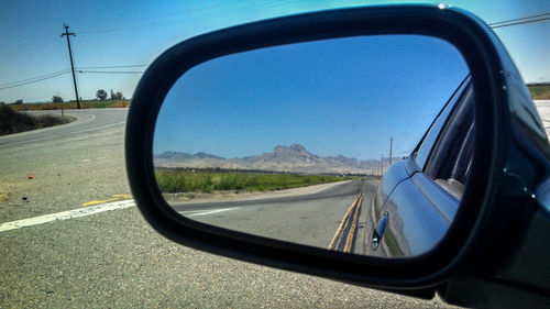 Reflection of road on side-view mirror