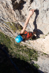 Low angle view of woman on rock at mountain