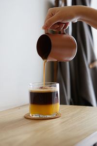 Close-up of person pouring drink