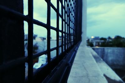 Close-up of railing against sky