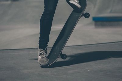 Low section of man skateboarding in park