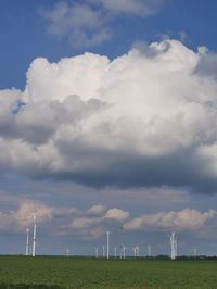 Windmill on field against sky
