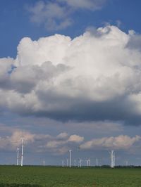 Windmill on field against sky