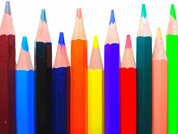 Close-up of colored pencils against white background