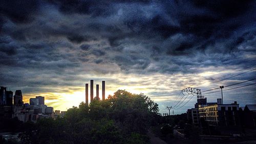 Buildings against cloudy sky at sunset