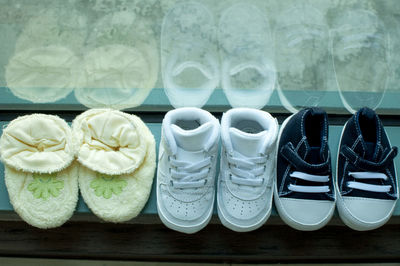 High angle view of baby shoes on window sill