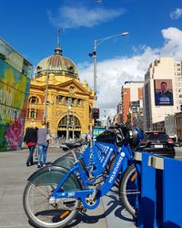 Bicycles against sky in city